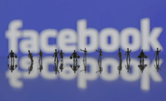3D-printed models of people are seen in front of a Facebook logo in this photo illustration taken June 9, 2016.